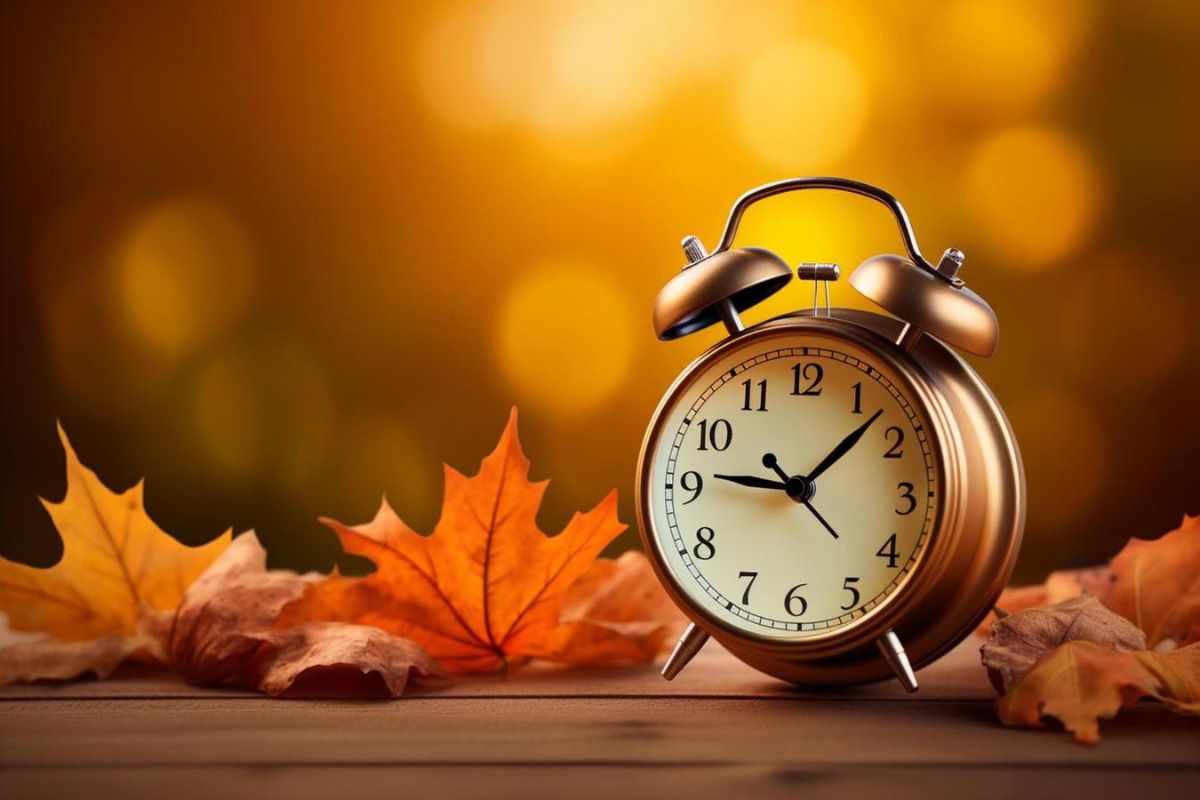 Clock with maple leaves fall background